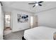 Bedroom showcasing tray ceiling, ceiling fan and an attached bathroom with a vanity at 90 Lake Avalon Ct, Dallas, GA 30157