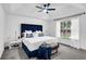 Bright bedroom featuring tray ceiling, ceiling fan, and large window with natural light at 90 Lake Avalon Ct, Dallas, GA 30157