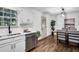 Open-concept dining area with modern light fixtures and stainless steel appliances at 90 Lake Avalon Ct, Dallas, GA 30157