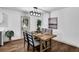 Bright dining area featuring a stylish light fixture and a table set for four at 90 Lake Avalon Ct, Dallas, GA 30157