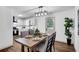 Bright dining room with wood floors, modern light fixture and a view to the kitchen at 90 Lake Avalon Ct, Dallas, GA 30157