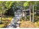 A front aerial view of a home showcasing the garage, driveway, and landscaped yard at 90 Lake Avalon Ct, Dallas, GA 30157