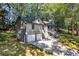 A side aerial view of a home showcasing the garage, driveway, and landscaped yard at 90 Lake Avalon Ct, Dallas, GA 30157
