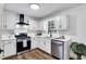 Modern kitchen with stainless steel appliances, updated cabinets, and new countertops at 90 Lake Avalon Ct, Dallas, GA 30157