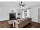 Cozy living room features a fireplace, wood floors and a neutral color scheme at 90 Lake Avalon Ct, Dallas, GA 30157