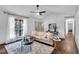 Well-lit living room with a cozy sofa, large window, and stylish decor at 90 Lake Avalon Ct, Dallas, GA 30157