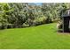 Lush backyard with well-manicured lawn and mature trees, providing a serene outdoor space at 1105 Sterling Brooke Dr, Alpharetta, GA 30022