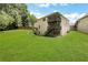 Large backyard featuring a spacious lawn and rear view of a two-story home with a porch at 1105 Sterling Brooke Dr, Alpharetta, GA 30022