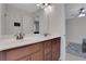 Bright bathroom featuring double sinks, a large mirror, and wooden cabinets at 1105 Sterling Brooke Dr, Alpharetta, GA 30022