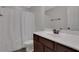 Functional bathroom with a shower-tub combo, white shower curtain and single sink vanity at 1105 Sterling Brooke Dr, Alpharetta, GA 30022