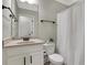 Bathroom with a white vanity, granite countertop, and a shower with a white curtain at 1105 Sterling Brooke Dr, Alpharetta, GA 30022