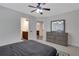 Bedroom with a ceiling fan, gray dresser, and connecting bathroom at 1105 Sterling Brooke Dr, Alpharetta, GA 30022