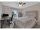 Cozy bedroom featuring a ceiling fan, natural light, and modern gray furnishings at 1105 Sterling Brooke Dr, Alpharetta, GA 30022