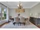 Elegant dining room with natural light, chandelier, and seating for six at 1105 Sterling Brooke Dr, Alpharetta, GA 30022