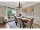 Elegant dining room with natural light, chandelier, and seating for six at 1105 Sterling Brooke Dr, Alpharetta, GA 30022