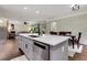 Kitchen island with a stainless steel dishwasher, white countertop and views to the living and dining areas at 1105 Sterling Brooke Dr, Alpharetta, GA 30022
