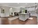 Open concept kitchen with white cabinets, central island with breakfast bar, and adjacent dining area at 1105 Sterling Brooke Dr, Alpharetta, GA 30022