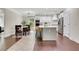 Bright kitchen with white cabinets, stainless steel appliances, central island and a connecting dining area at 1105 Sterling Brooke Dr, Alpharetta, GA 30022