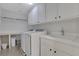 Well-lit laundry room featuring modern washer and dryer, and ample storage space at 1105 Sterling Brooke Dr, Alpharetta, GA 30022