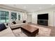 Bright living room featuring modern furnishings, hardwood floors, and large windows with natural light at 1105 Sterling Brooke Dr, Alpharetta, GA 30022
