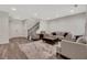 Spacious living room with hardwood floors, staircase, and modern neutral-toned furniture at 1105 Sterling Brooke Dr, Alpharetta, GA 30022