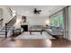 Bright living room features a fireplace, staircase and views of the outdoors at 1105 Sterling Brooke Dr, Alpharetta, GA 30022