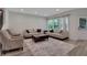 Bright living room featuring modern furnishings, hardwood floors, and large windows with natural light at 1105 Sterling Brooke Dr, Alpharetta, GA 30022