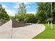 Community sidewalk lined with mature trees and landscaping, offering a serene walking experience at 1105 Sterling Brooke Dr, Alpharetta, GA 30022