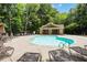 Community pool featuring a spacious sundeck, comfortable lounge chairs, and a covered pavilion area at 1105 Sterling Brooke Dr, Alpharetta, GA 30022