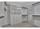 Spacious walk-in closet featuring custom shelving, drawers, and mirrored doors for ample storage at 1105 Sterling Brooke Dr, Alpharetta, GA 30022