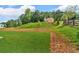 Spacious backyard with manicured lawn, and natural wooded surroundings create a serene outdoor space at 4563 Sweetlake Court Sw, Mableton, GA 30127