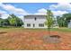 Home's backyard with spacious lot, green grass, and young tree at 4563 Sweetlake Court Sw, Mableton, GA 30127
