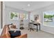 Bright home office space with a comfortable couch, desk, and natural light from the windows at 4563 Sweetlake Court Sw, Mableton, GA 30127