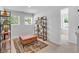 Stylishly decorated bedroom with a leather ottoman, shelving units, and natural light from two windows at 4563 Sweetlake Court Sw, Mableton, GA 30127