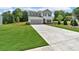 Charming two-story home with a gray two-car garage and a well-manicured front lawn at 4563 Sweetlake Court Sw, Mableton, GA 30127