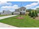 Beautiful home with manicured lawn and landscaping, showcasing a long concrete driveway at 4563 Sweetlake Court Sw, Mableton, GA 30127