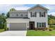 Charming two-story home with a gray two-car garage and a well-manicured front yard at 4563 Sweetlake Court Sw, Mableton, GA 30127