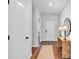 Inviting foyer featuring hardwood floors, a console table with lamps, and a round mirror at 4563 Sweetlake Court Sw, Mableton, GA 30127