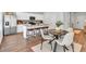 Modern kitchen featuring a large island with bar seating, stainless steel appliances, and a dining area for casual meals at 4563 Sweetlake Court Sw, Mableton, GA 30127