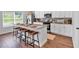 Contemporary kitchen featuring an island with seating, stainless steel appliances, and granite countertops for meal preparation at 4563 Sweetlake Court Sw, Mableton, GA 30127