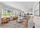 Inviting living room featuring hardwood floors, large windows, modern furniture, and seamlessly flowing into the kitchen area at 4563 Sweetlake Court Sw, Mableton, GA 30127