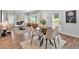 Open-concept space with a living room featuring a fireplace, alongside a dining area with natural light and modern decor at 4563 Sweetlake Court Sw, Mableton, GA 30127
