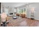 Bright living room with hardwood floors, modern furniture, and ample natural light at 4563 Sweetlake Court Sw, Mableton, GA 30127