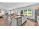 Inviting kitchen and living room layout with modern appliances, island seating, fireplace, and a connected dining area at 4563 Sweetlake Court Sw, Mableton, GA 30127