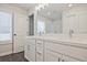 Bathroom featuring double sink vanity, a large mirror, and modern lighting at 907 Agate Ln, Lawrenceville, GA 30043