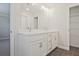 Bright bathroom features double sink vanity with modern hardware, and walk-in closet at 907 Agate Ln, Lawrenceville, GA 30043