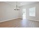 Inviting dining area boasting hardwood floors, modern lighting, and a door leading to outdoor space at 907 Agate Ln, Lawrenceville, GA 30043