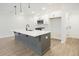 Well-equipped kitchen with white cabinets, modern appliances, and a functional layout at 907 Agate Ln, Lawrenceville, GA 30043