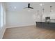 Bright living room featuring hardwood floors, a ceiling fan, and an open floor plan connected to the kitchen at 907 Agate Ln, Lawrenceville, GA 30043