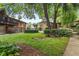 Lush community backyard with manicured landscaping and mature trees at 115 Biscayne Nw Dr # E3, Atlanta, GA 30309
